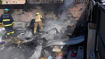 Israel-Hamas War: Israeli firefighters extinguish fire at a site struck by a rocket fired from the Gaza Strip, in the southern Israeli town of Sderot. (AP) Israel-Hamas War: Israeli firefighters extinguish fire at a site struck by a rocket fired from the Gaza Strip, in the southern Israeli town of Sderot. (AP)