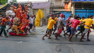 Porters carry an clay idol of goddess Durga from clay modellers studio to worship place for the Durga Puja festival in Kolkata. (PTI) Porters carry an clay idol of goddess Durga from clay modellers studio to worship place for the Durga Puja festival in Kolkata. (PTI)