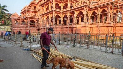 A security official with a sniffer dog inspects during final preparation where Ayodhya's Ram Temple comes alive at a community Durga Puja pandal, ahead of Durga Puja festival in Kolkata. Union Home Minister Amit Shah is likely to come tomorrow to inaugurate this puja pandal. (PTI) A security official with a sniffer dog inspects during final preparation where Ayodhya's Ram Temple comes alive at a community Durga Puja pandal, ahead of Durga Puja festival in Kolkata. Union Home Minister Amit Shah is likely to come tomorrow to inaugurate this puja pandal. (PTI)
