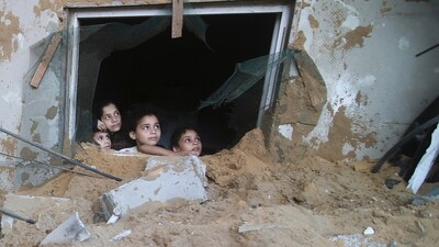 Palestinian children look at the building of the Zanon family, destroyed in Israeli airstrikes in Rafah, Gaza Strip, (AP) Palestinian children look at the building of the Zanon family, destroyed in Israeli airstrikes in Rafah, Gaza Strip, (AP)