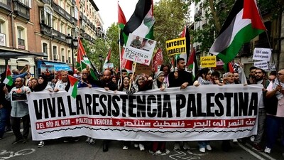 Demonstrators wave Palestinian flags and hold signs as they attend a rally in support of the Palestinian people in Madrid on October 15, 2023. (AFP) Demonstrators wave Palestinian flags and hold signs as they attend a rally in support of the Palestinian people in Madrid on October 15, 2023. (AFP)