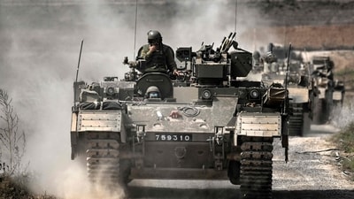 Israeli army Puma armoured personnel carrierss (APCs) move in a column near the Gaza border in southern Israel (AFP) Israeli army Puma armoured personnel carrierss (APCs) move in a column near the Gaza border in southern Israel (AFP)