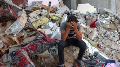 Israel-Hamas War: A Palestinian youth reacts as he sits on the rubble of a destroyed home following an Israeli military strike on the Rafah refugee camp, in the southern of Gaza Strip. (AFP) Israel-Hamas War: A Palestinian youth reacts as he sits on the rubble of a destroyed home following an Israeli military strike on the Rafah refugee camp, in the southern of Gaza Strip. (AFP)