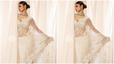 If you are looking for an elegant yet glamorous saree option, then Mouni Roy's stunning white net saree can be your ideal outfit inspiration for day 2 of Navratri. Embellished with intricate floral embroidery at the borders and paired with a bralette-style blouse, it's the perfect blend of hotness and style. Add some chunky silver jewellery, tie your hair into a neat bun and you are ready to turn heads. (Instagram/@imouniroy) If you are looking for an elegant yet glamorous saree option, then Mouni Roy's stunning white net saree can be your ideal outfit inspiration for day 2 of Navratri. Embellished with intricate floral embroidery at the borders and paired with a bralette-style blouse, it's the perfect blend of hotness and style. Add some chunky silver jewellery, tie your hair into a neat bun and you are ready to turn heads. (Instagram/@imouniroy)