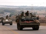 Israel-Hamas War: Israeli soldiers ride in their armoured vehicles towards the border with the Gaza Strip.
