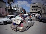 Palestinians salvage what little of their belongings they could from their homes during a 12-hour cease-fire in Gaza City