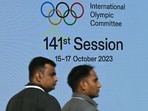 Venue staff walk past a digital screen on the first day of the 141st Session of the International Olympic Committee (IOC), in Mumbai Venue staff walk past a digital screen on the first day of the 141st Session of the International Olympic Committee (IOC), in Mumbai