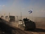 A convoy of Israeli military vehicles drives down a road at an undisclosed location on the border with the Gaza Strip A convoy of Israeli military vehicles drives down a road at an undisclosed location on the border with the Gaza Strip