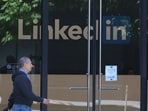 A pedestrian walks by a sign at a LinkedIn office A pedestrian walks by a sign at a LinkedIn office