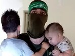 A Hamas terrorists with toddlers as hostages in Gaza.