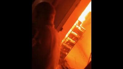 A video grab of a fire wing official of the Post Graduate Institute of Medical Education and Research (PGIMER), Chandigarh, trying to douse flames in the basement of the advanced eye centre on Monday morning. (HT Photo)