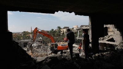 Israel-Hamas War: Palestinians search for casualties under the rubble at a site of a house destroyed by Israeli strikes in Khan Younis in the southern Gaza Strip. (Reuters)