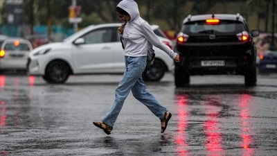 A girl crosses a street during a heavy rain in Jammu, India, Monday, Oct.16, 2023. (AP Photo/Channi Anand) (AP) A girl crosses a street during a heavy rain in Jammu, India, Monday, Oct.16, 2023. (AP Photo/Channi Anand) (AP)