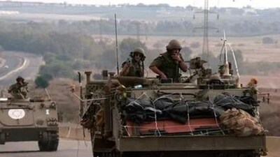 Israel-Hamas War: Israeli soldiers ride in their armoured vehicles towards the border with the Gaza Strip. (AFP) Israel-Hamas War: Israeli soldiers ride in their armoured vehicles towards the border with the Gaza Strip. (AFP)