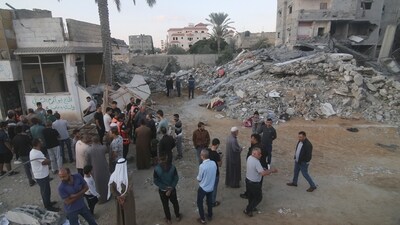 Israel-Hamas War: Palestinians stand by a building destroyed in an Israeli airstrike in the Rafah border, Gaza Strip. (AP) Israel-Hamas War: Palestinians stand by a building destroyed in an Israeli airstrike in the Rafah border, Gaza Strip. (AP)