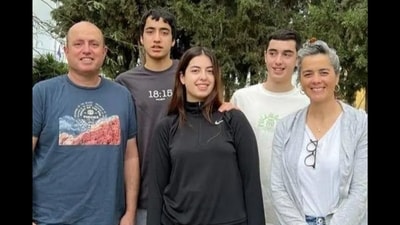 Aviv Kutz, 54, was found embracing his wife, Livnat, 49, daughter, Rotem, 19, and sons Yonatan, 17, and Yiftach, 17 (Rachel Elior/Facebook) Aviv Kutz, 54, was found embracing his wife, Livnat, 49, daughter, Rotem, 19, and sons Yonatan, 17, and Yiftach, 17 (Rachel Elior/Facebook)