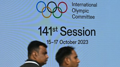 Venue staff walk past a digital screen on the first day of the 141st Session of the International Olympic Committee (IOC), in Mumbai (AFP) Venue staff walk past a digital screen on the first day of the 141st Session of the International Olympic Committee (IOC), in Mumbai (AFP)