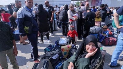 Israel-Hamas War: Palestinians, some with foreign passports hoping to cross into Egypt and others waiting for aid wait at the Rafah crossing in the southern Gaza strip. (AFP) Israel-Hamas War: Palestinians, some with foreign passports hoping to cross into Egypt and others waiting for aid wait at the Rafah crossing in the southern Gaza strip. (AFP)