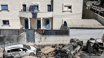 Israel-Hamas War: Vehicles destroyed in an rocket attack allegedly fired from the Gaza Strip in the village of Arara in the Negev Desert. (AFP) Israel-Hamas War: Vehicles destroyed in an rocket attack allegedly fired from the Gaza Strip in the village of Arara in the Negev Desert. (AFP)