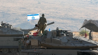 Israeli Merkava tanks are positioned in the north of Israel near the border with Lebanon on October 15. (AFP)