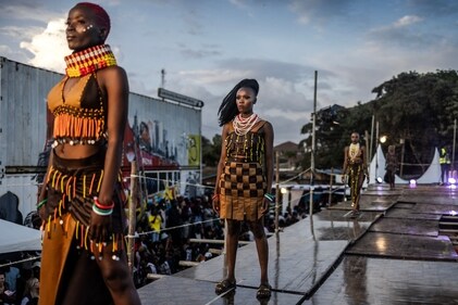 Models stand on the catwalk while showcasing designs at the main fashion show during the Kibera Fashion Week in the informal settlement of Kibera in Nairobi, on October 15, 2023. (Photo by LUIS TATO / AFP) Models stand on the catwalk while showcasing designs at the main fashion show during the Kibera Fashion Week in the informal settlement of Kibera in Nairobi, on October 15, 2023. (Photo by LUIS TATO / AFP)