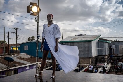 A model stands on the catwalk at the main fashion show during the Kibera Fashion Week in the informal settlement of Kibera in Nairobi, on October 15, 2023. (Photo by LUIS TATO / AFP) A model stands on the catwalk at the main fashion show during the Kibera Fashion Week in the informal settlement of Kibera in Nairobi, on October 15, 2023. (Photo by LUIS TATO / AFP)
