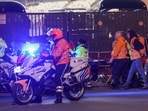 Emergency personnel carry a person on a stretcher outside King Baudouin Stadium after play was suspended after a shooting in Brussels, Belgium,