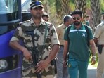 Pakistan's captain, Babar Azam (C) walks to board Pakistan's team bus amid security personnel upon landing at the airport in Ahmedabad Pakistan's captain, Babar Azam (C) walks to board Pakistan's team bus amid security personnel upon landing at the airport in Ahmedabad