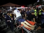 An injured person is assisted at Shifa Hospital after an Israeli air strike hit the nearby Al-Ahli Hospital, according to Gaza Health Ministry, in Gaza City, Gaza Strip, October 17, 2023.