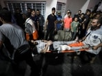 An injured person is assisted at Shifa Hospital after an Israeli air strike hit the nearby Al-Ahli Hospital, according to Gaza Health Ministry in Gaza City, Gaza Strip, October 17, 2023. REUTERS/Mohammed Al-Masri