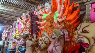 An artist applies final touches to an idol of goddess Durga ahead of the Durga Puja festival. (ANI Photo) An artist applies final touches to an idol of goddess Durga ahead of the Durga Puja festival. (ANI Photo)
