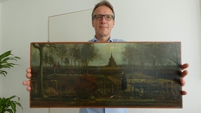 Dutch art detective Arthur Brand shows a portrait of him posing with the painting title "Parsonage Garden at Nuenen in Spring", painted by Vincent van Gogh. (AFP) Dutch art detective Arthur Brand shows a portrait of him posing with the painting title "Parsonage Garden at Nuenen in Spring", painted by Vincent van Gogh. (AFP)