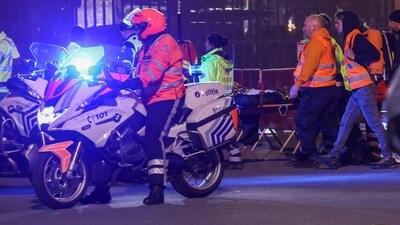 Emergency personnel carry a person on a stretcher outside King Baudouin Stadium after play was suspended after a shooting in Brussels, Belgium, (REUTERS)