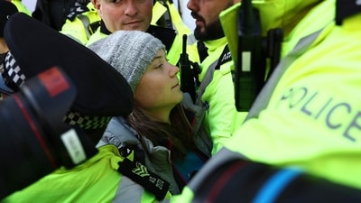 Swedish climate activist Greta Thunberg is arrested by police outside the InterContinental London Park Lane. (AFP) Swedish climate activist Greta Thunberg is arrested by police outside the InterContinental London Park Lane. (AFP)