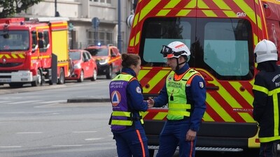 France School Stabbing: Rescue workers wait in front the Gambetta high school during bomb alert. (AP) France School Stabbing: Rescue workers wait in front the Gambetta high school during bomb alert. (AP)