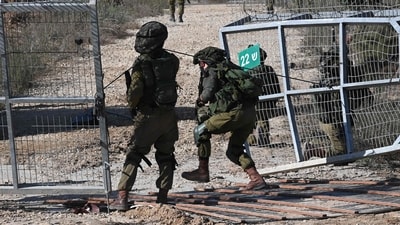 Israeli soldiers patrol a border fence gate with the Gaza Strip on October 15. (AFP) Israeli soldiers patrol a border fence gate with the Gaza Strip on October 15. (AFP)