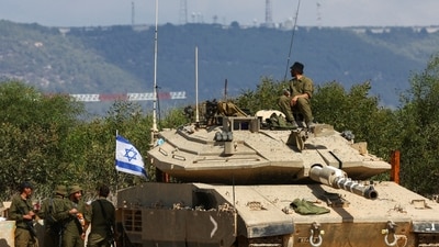 Israel-Hamas War: Israeli soldiers stand near to a tank near Israel's border with Lebanon in northern Israel. (Reuters)
