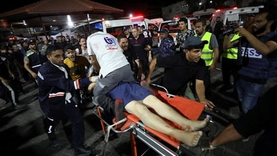 An injured person is assisted at Shifa Hospital after an Israeli air strike hit the nearby Al-Ahli Hospital, according to Gaza Health Ministry, in Gaza City, Gaza Strip, October 17, 2023. (REUTERS)