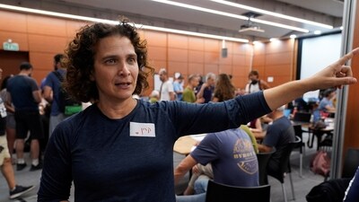 Professor Karine Nahon, head of the missing civilians' war room, gestures as she describes the initiative by cyber professionals in Tel Aviv. (Reuters)