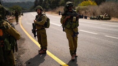 Israeli soldiers patrol a road near the border between Israel and Lebanon on October 16. (AP)