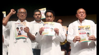 Madhya Pradesh Congress President Kamal Nath with Rajya Sabha MP Digvijay Singh and party leaders during the release of the party's manifesto (Vachan Patra) ahead of the State Assembly elections in Bhopal on Tuesday. (ANI)