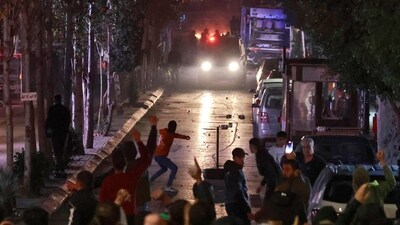 People clash with Palestinian security forces during a rally in solidarity with the Palestinians of the Gaza Strip in the West Bank city of Ramallah, on October 17, 2023. (AFP) People clash with Palestinian security forces during a rally in solidarity with the Palestinians of the Gaza Strip in the West Bank city of Ramallah, on October 17, 2023. (AFP)