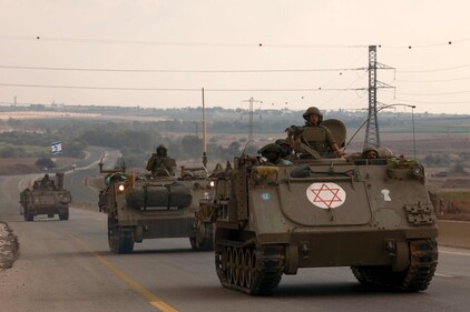 Israeli soldiers ride in their armoured vehicles towards the border with the Gaza Strip on October 16, 2023, amid the ongoing battles between Israel and the Palestinian group Hamas. (AFP)