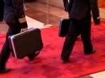 Two Russian naval officers carry what is thought to be Russia's nuclear briefcase.