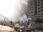 Israel-Hamas War: Palestinians run by the building destroyed in an Israeli airstrike on Nusseirat refugee camp, Gaza Strip.