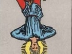 The image shows the hanged man tarot card.
