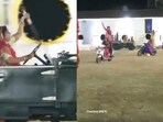 The image shows women performing 'Garba' while riding on bikes and cars with swords in their hands. 