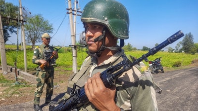 Border Security Force (BSF) personnel stand guard near India-Pakistan border in the Arnia sector, on the outskirts of Jammu, on Wednesday. (PTI)