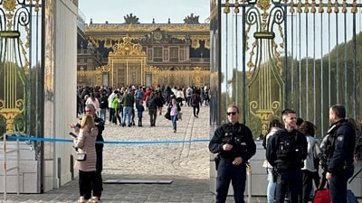 French police stand guard in front of the Chateau de Versailles (Versailles Palace) as tourists enter again after the Palace was evacuated for security reasons, in Versailles, near Paris, France. (Reuters)