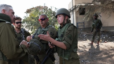 Israel-Hamas War: Members of the Israeli Defense Forces speak with each other, following a deadly infiltration by Hamas gunmen from the Gaza Strip. (Reuters)